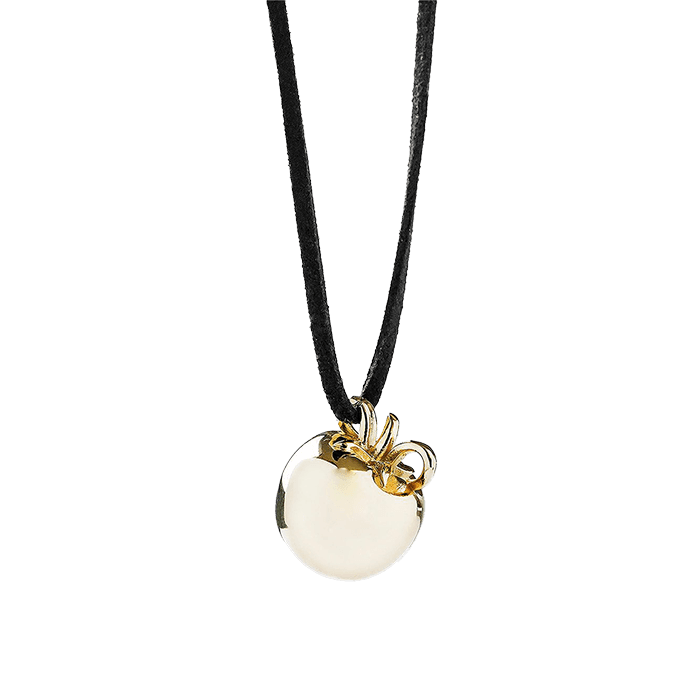 A gold pendant in the form of a tomato on a long black lace, an elegant jewelry accessory.