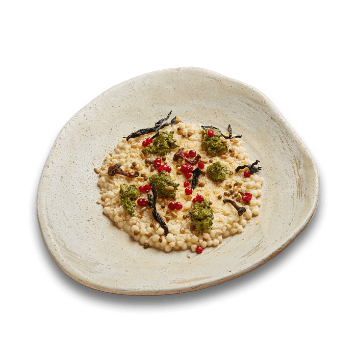 Rolled millet in dough, cooked with spices, herbs, and brynza cheese, served on a plate