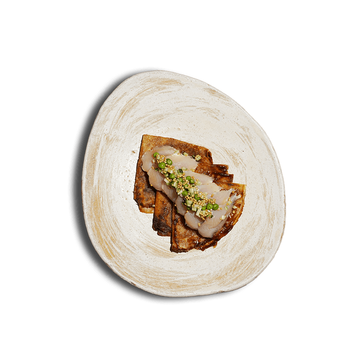 Plate of thin Ukrainian crepes with char, soaked in butter, from 100 Rokiv Tomu Vpered.