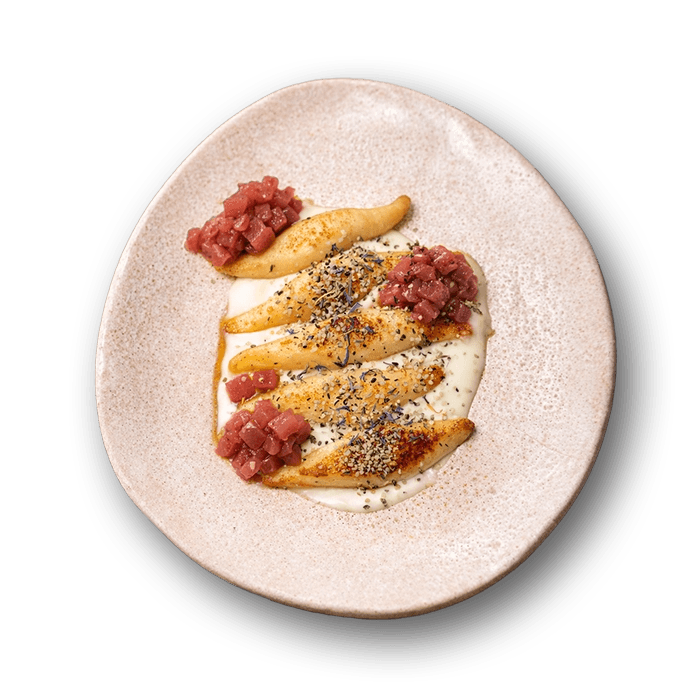 Palyushky dumplings with cheese, caramelized pear, and cherry with juniper