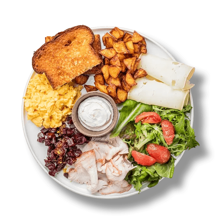 A hearty breakfast with farm turkey, beets, okata, butter cream with horseradish, warm bread, and fresh vegetables from 100 rokiv tomu vpered.